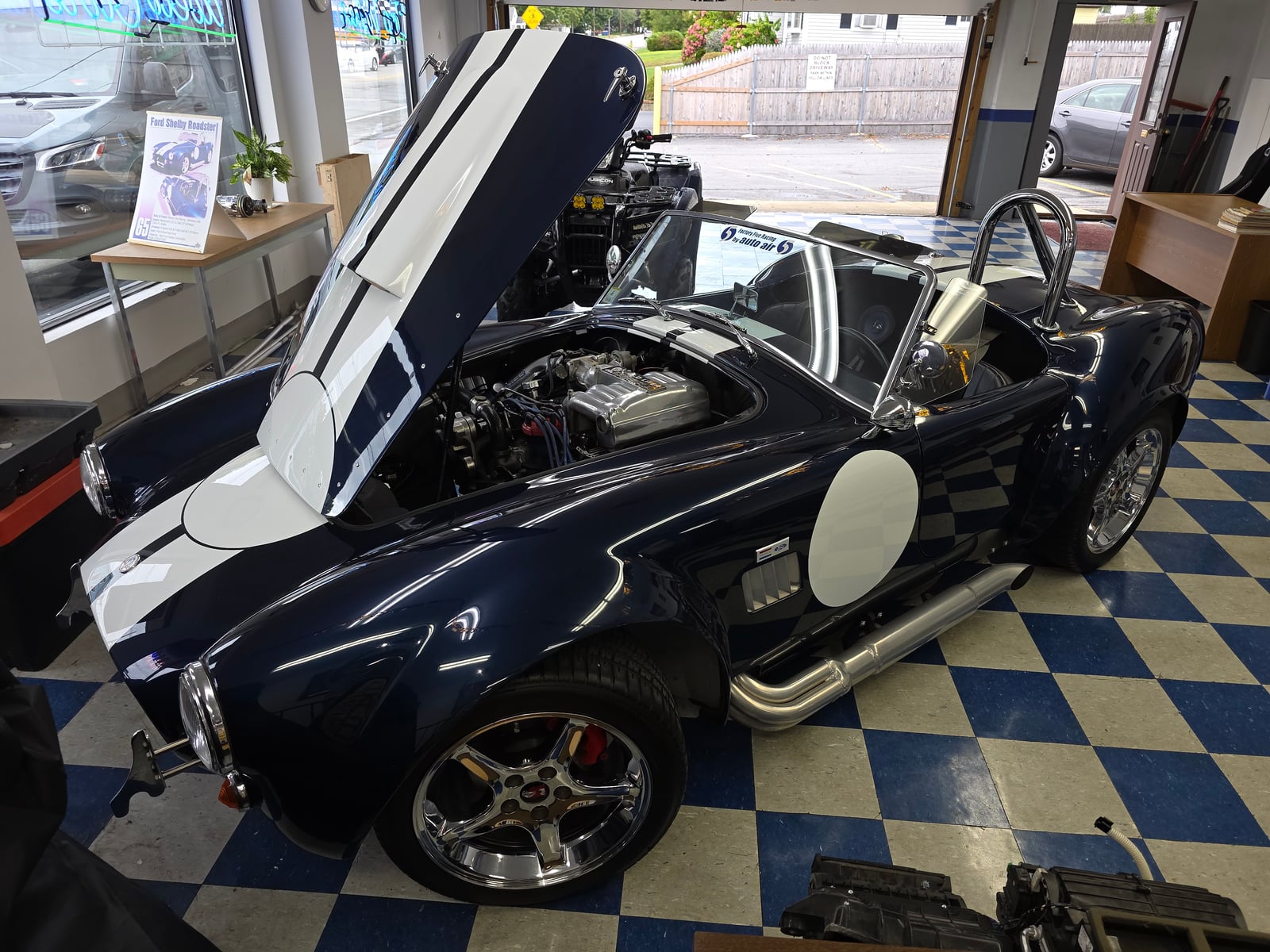 A custom-built Shelby Cobra replica, built in-house by Auto Air R.J. Pelletier, on display in the showroom